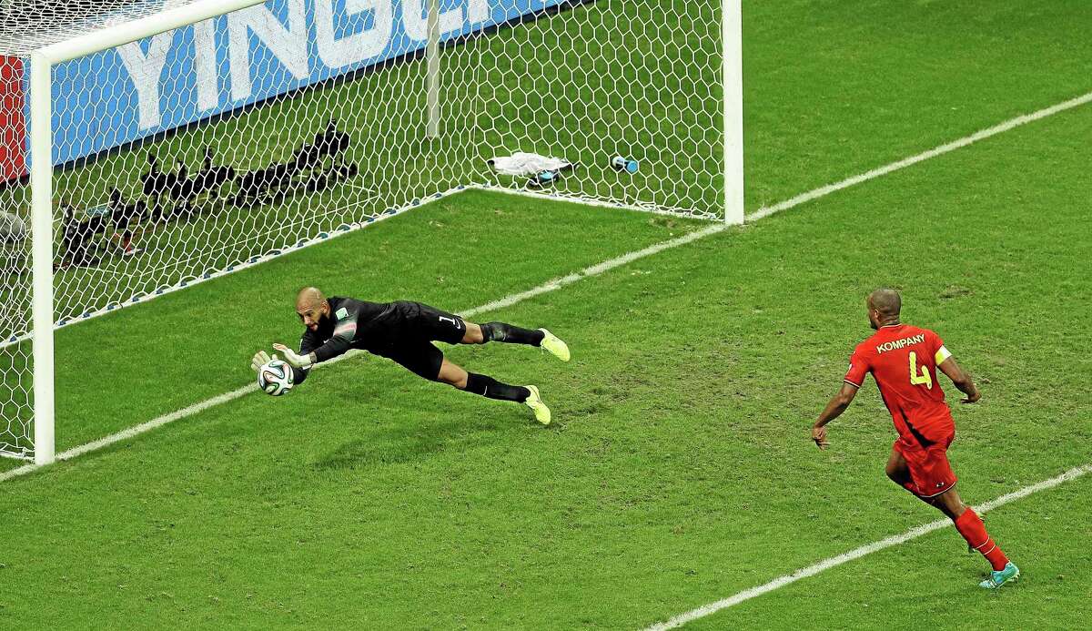 United States goalkeeper Tim Howard makes a save on Belgium’s Vincent Kompany during Tuesday’s World Cup match at the Arena Fonte Nova in Salvador, Brazil.