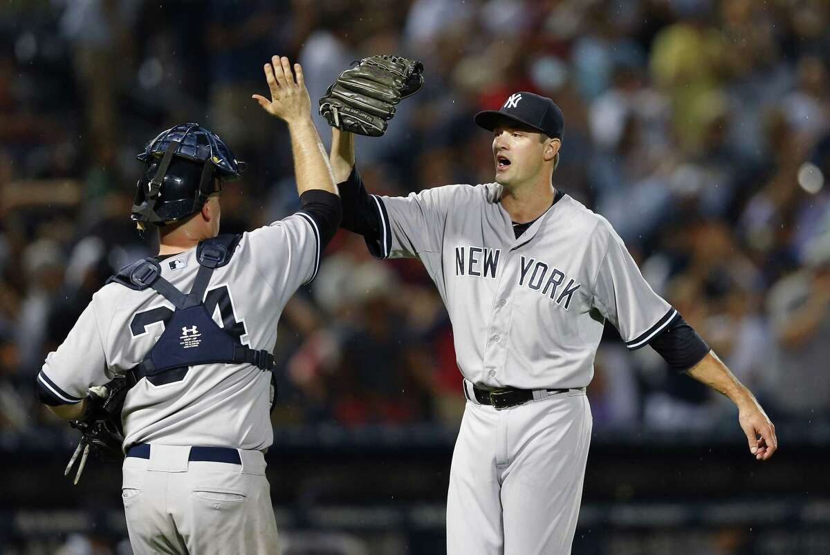 New York Yankees closer Andrew Miller and catcher Brian McCann celebrate after getting the final out of their 3-1 win over the Braves on Saturday in Atlanta.