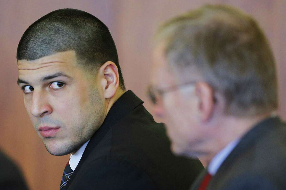 Former New England Patriots tight end Aaron Hernandez, left, attends a pretrial hearing in Fall River, Mass. on Dec. 22, 2014.