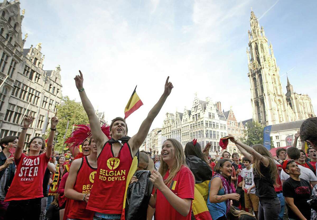 Belgian fans cheer after Belgium scored a goal as they watch the soccer match on a giant screen in the Grote Markt in Antwerp, Belgium on Sunday, June 22, 2014. Belgium scored a 1-0 victory over Russia during the group H World Cup soccer match between Belgium and Russia at the Maracana Stadium in Rio de Janeiro, Brazil. (AP Photo/Virginia Mayo)