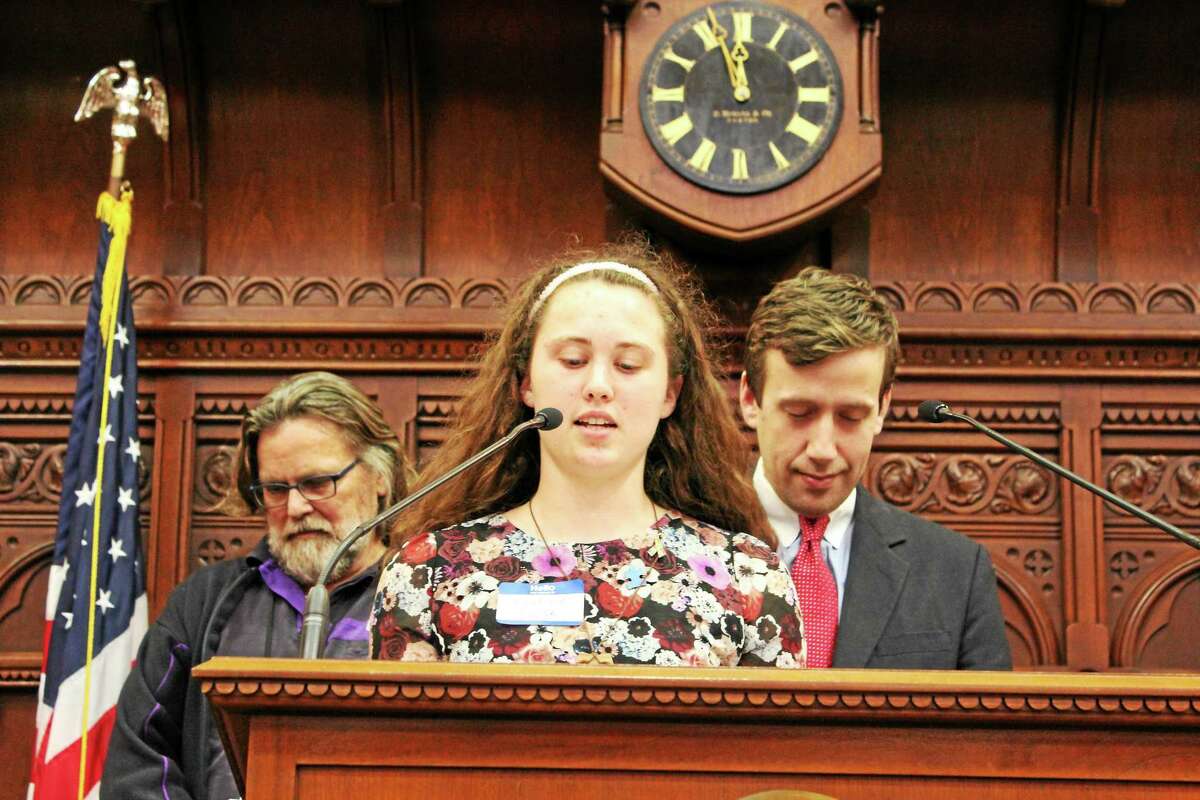 Middletown High School Jackie Pawlak spoke as a guest chaplain in the House Chamber recently after being recognized for her autism awareness project. Shown behind her are state Reps. Jack Hennessy and Matt Lesser.