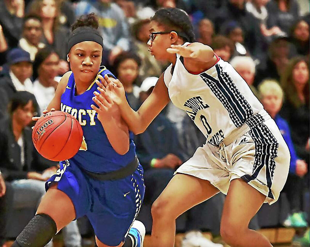 Mercy’s Destine Perry drives to the paint as Hillhouse guard Tyee Allen defends as the Tigers defeat the Academics, 64-45, Wednesday at Hillhouse.