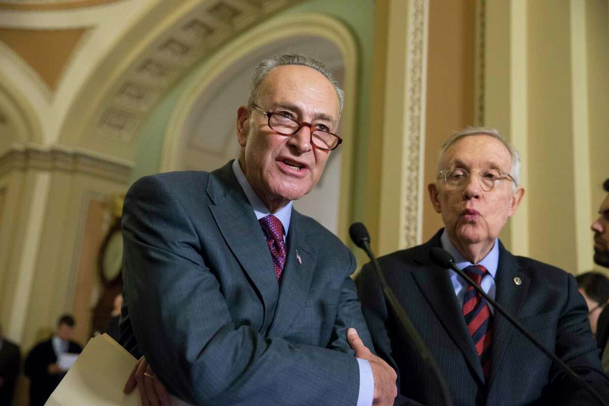 In this Dec. 8, 2015 photo, Sen. Chuck Schumer, D-N.Y., joined by Senate Minority Leader Harry Reid, D-Nev., right, criticizes Republicans for not doing enough to stop gun violence, during a news conference on Capitol Hill in Washington.