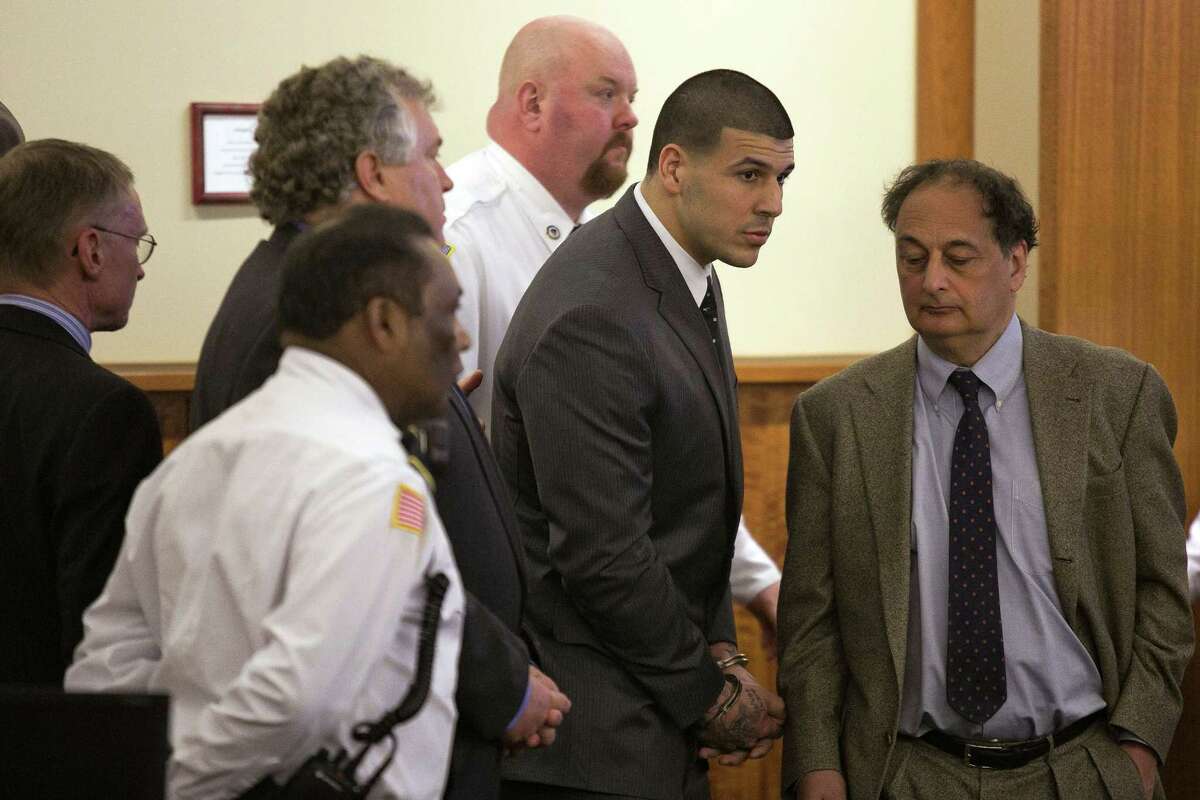 Former New England Patriot Aaron Hernandez stands up after he is sentenced to life in prison at his murder trial last Wednesday at the Bristol County Superior Court in Fall River, Mass.