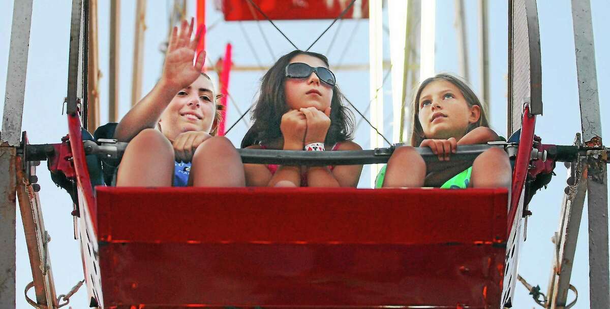 catherine avalone - Middletown Press file photo Middletown resident Alexia Salafia,12 waves to her Mom during a ride on the ferrish wheel with her younger sister Arianna, 11 and a friend, Nicole Zalewski, 11 at the Haddam Neck Fair in this file photo.