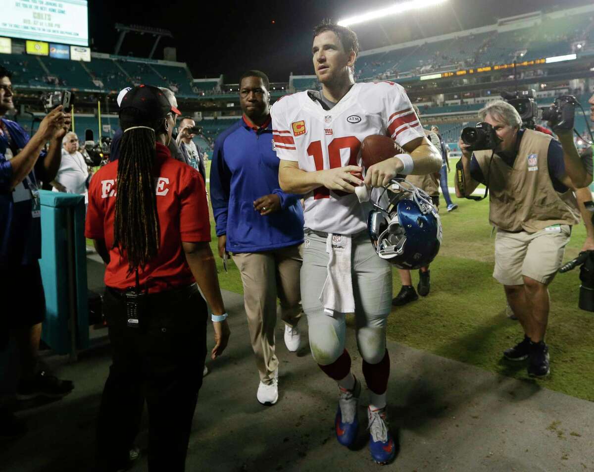 Giants quarterback Eli Manning leaves the field after a 31-24 win over the Dolphins in Miami.