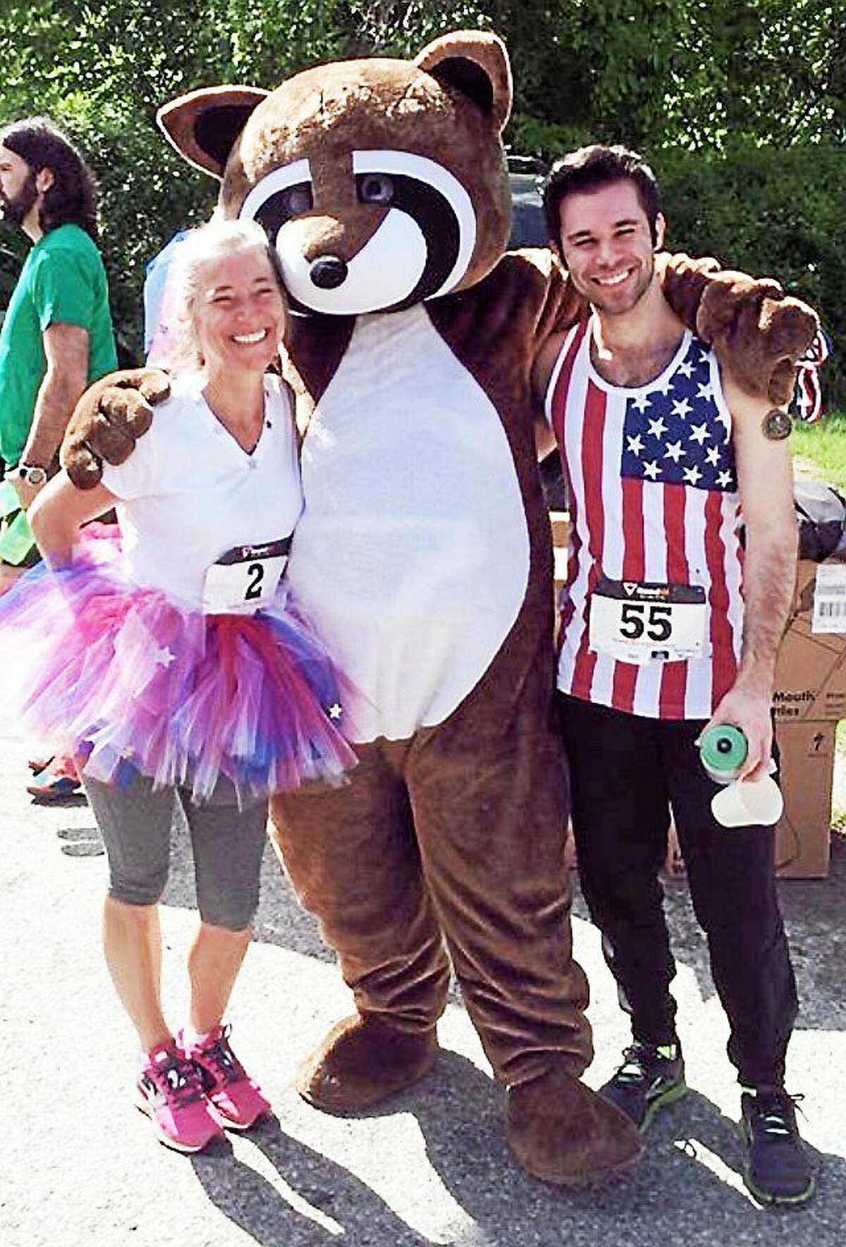 Middletown runner Julie Cesare, left, wears her trademark tutu to one of the many races she’s taken part in since suffering a traumatic brain injury. She is pictured with her son, Travis Rock, also a survivor of a traumatic head injury.
