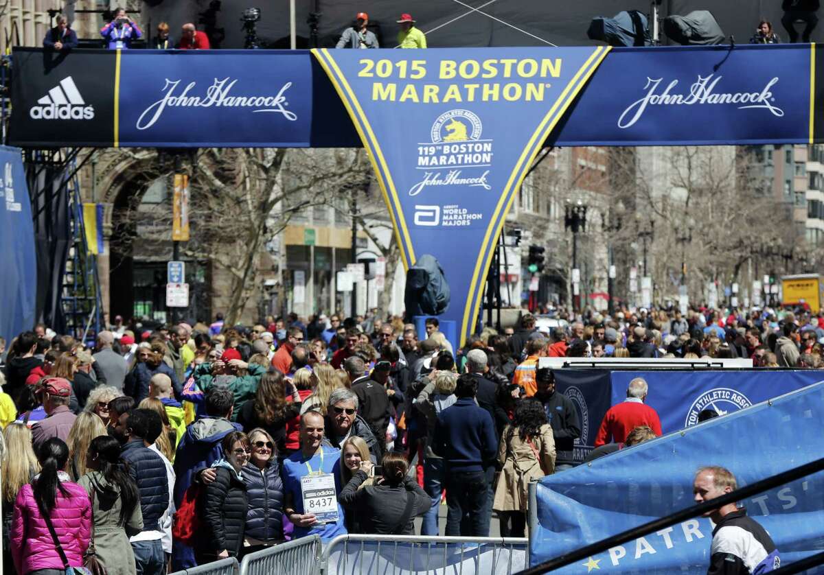 Runners and spectators crowd the finish line on Boylston Street on Sunday.