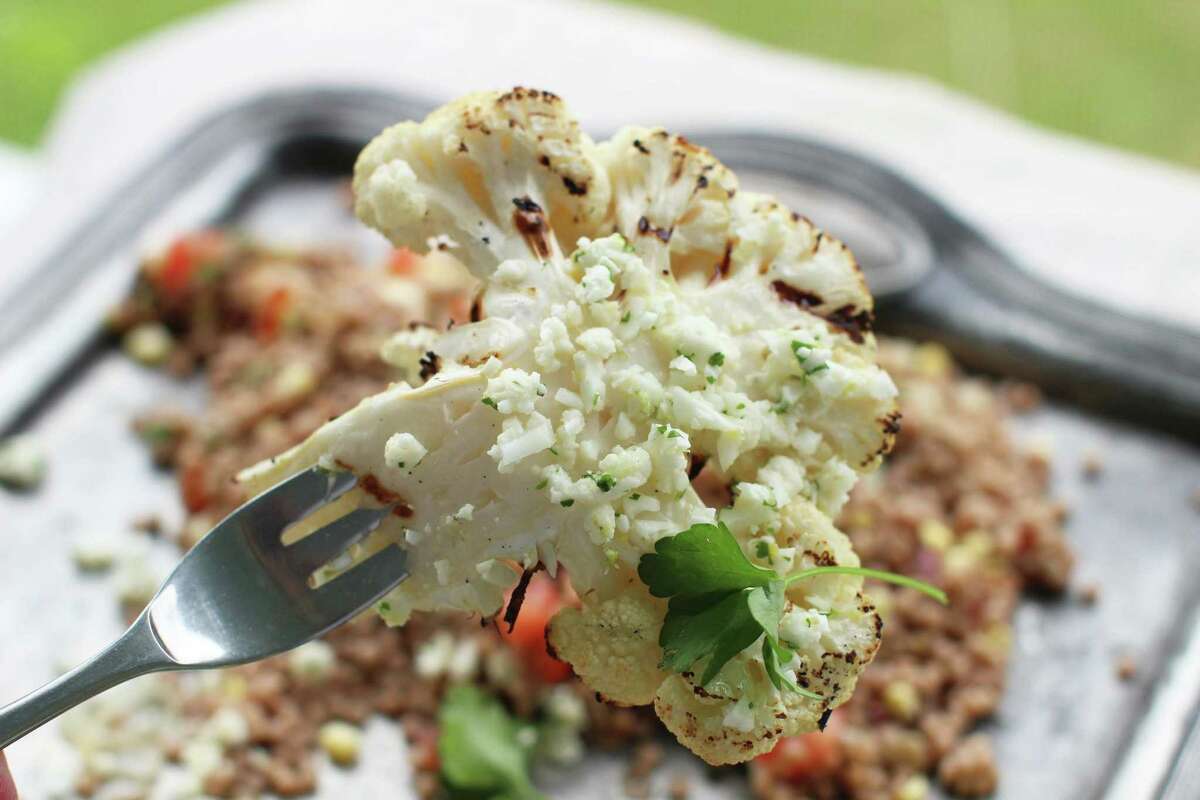 This June 8, 2015, file photo shows grilled cauliflower steaks with lemon lime feta gremolata in Concord, N.H. Back in 2013, the question was posed: Is cauliflower the new kale? It’s 2015, people who have just discovered baked and roasted cauliflower, mashed cauliflower, cauliflower pasta sauce, cauliflower pizza crust and fancy arrangements of what is a fine food delicately plated in fine restaurants.