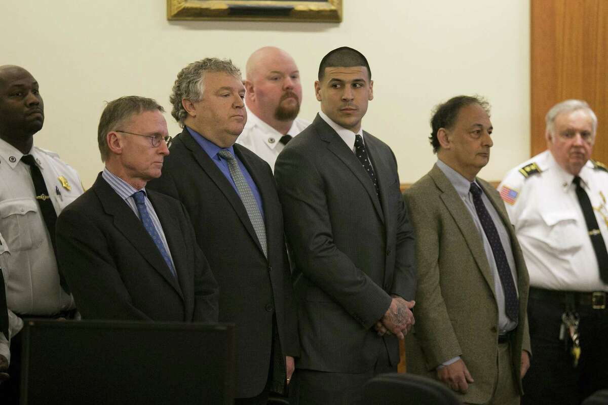 Former New England Patriot Aaron Hernandez, center, stands with his defense attorneys as the verdict is read in his murder trial on Wednesday at Bristol County Superior Court in Fall River, Mass. Hernandez was found guilty of first-degree murder.