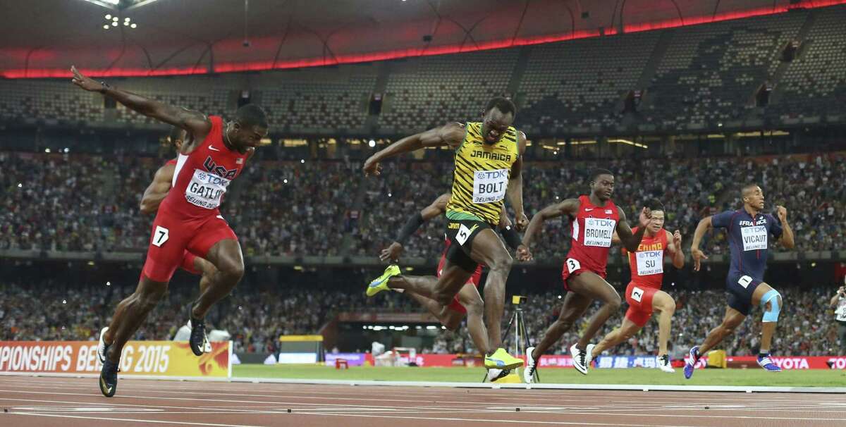 Jamaica’s Usain Bolt crosses the finish line to win the men’s 100 meter final at the World Athletics Championships in Beijing on Sunday.