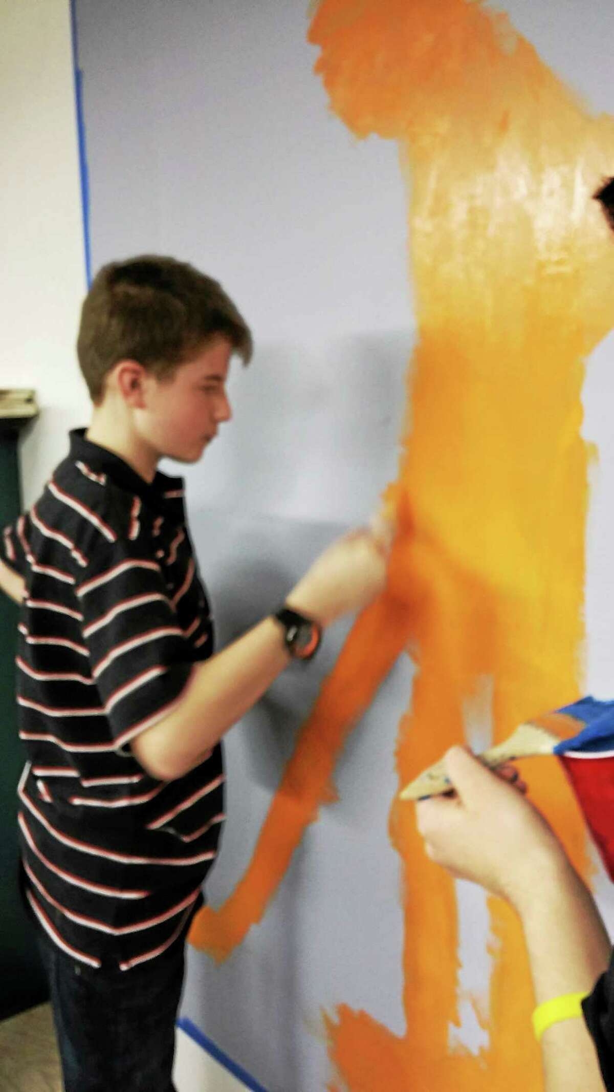 Middletown students paint a mural at the Hamden offices of Special Olympics of Connecticut as part of a Unified Arts project.
