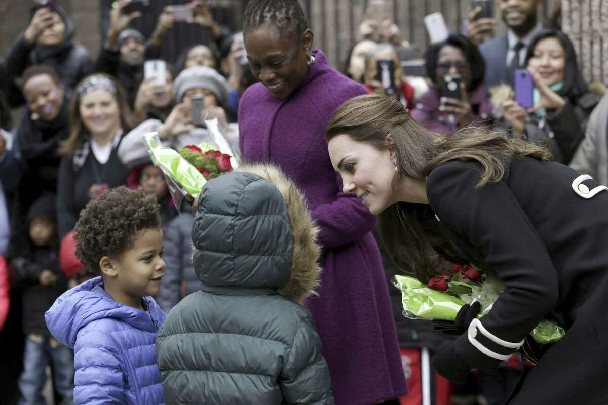 Kate, the Duchess of Cambridge, right, and Chirlane McCray, the first lady of New York City, center, receive flowers from Andrew, 5, left, and Mila, 6, before leaving the Northside Center for Childhood Development, Monday, Dec. 8, 2014 in New York. Kate and Prince William arrived in New York City on Sunday, their first official visit to the U.S. since a 2011 trip to California and their first taste of the Big Apple. (AP Photo/Seth Wenig, Pool)