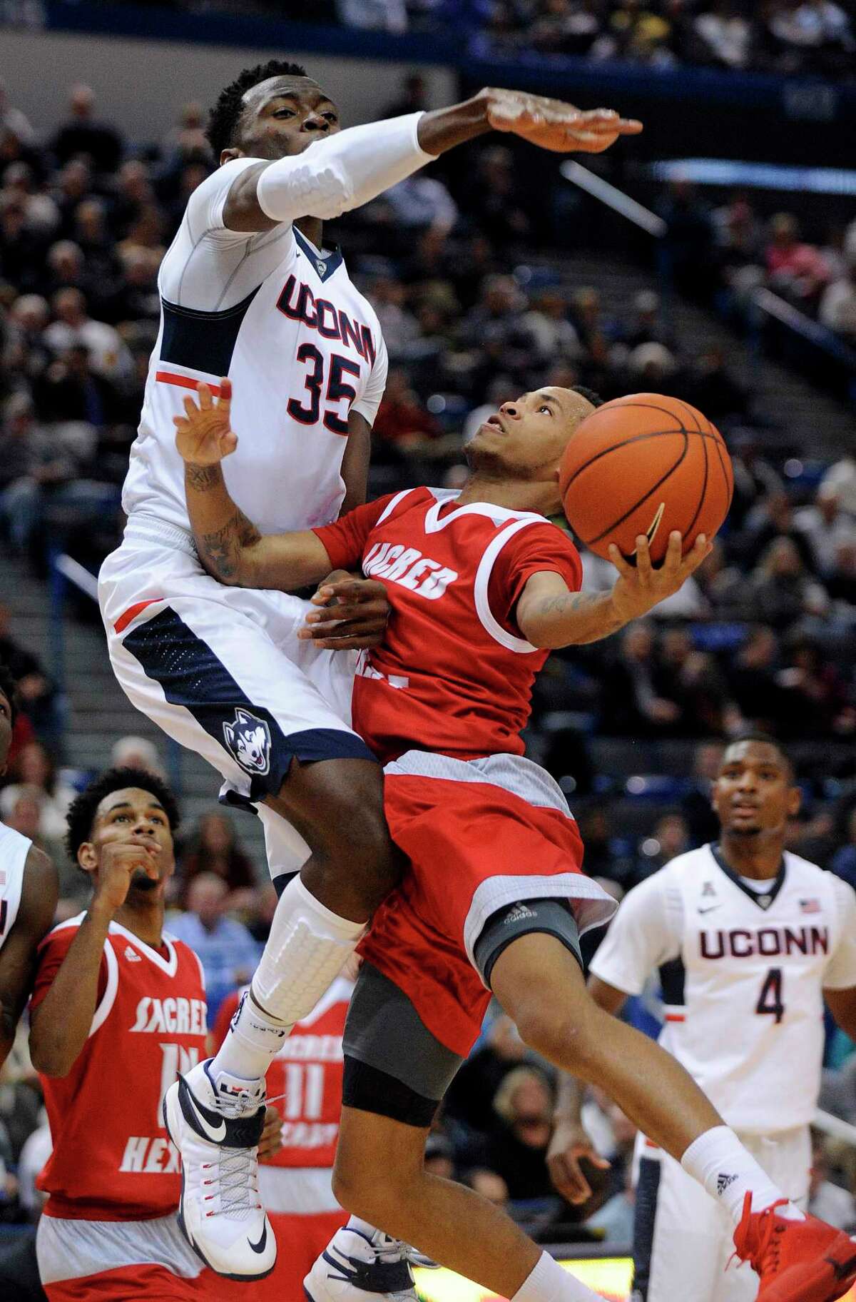 Connecticut’s Amida Brimah (35) guards Sacred Heart’s Cane Broome during the first half Wednesday.