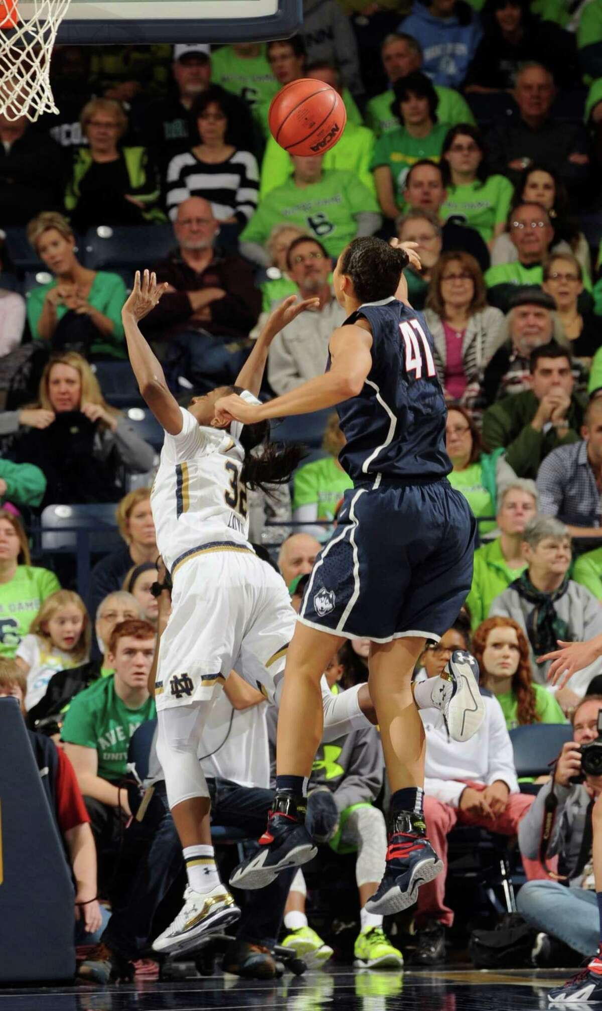 Connecticut forward Kiah Stokes blocks a shot by Notre Dame guard Jewell Loyd, left, in the second half of an NCAA college basketball game with Notre Dame, Saturday Dec. 6, 2014, in South Bend, Ind. Connecticut won 76-58. (AP Photo/Joe Raymond)