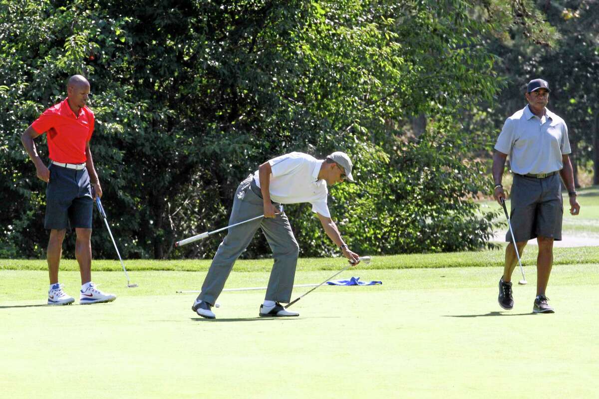 President Barack Obama, center, golfs with Ray Allen, left, and former NFL player Ahmad Rashad on Saturday at Farm Neck Golf Club in Oak Bluffs, Mass.