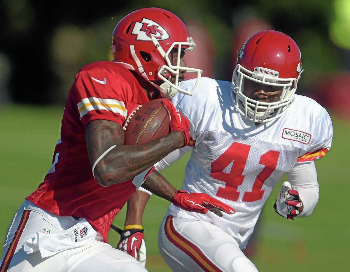 Kansas City Chiefs receiver Dwayne Bowe (82) tries to elude Malcolm Bronson (41) during training camp Tuesday in St. Joseph. Mo.
