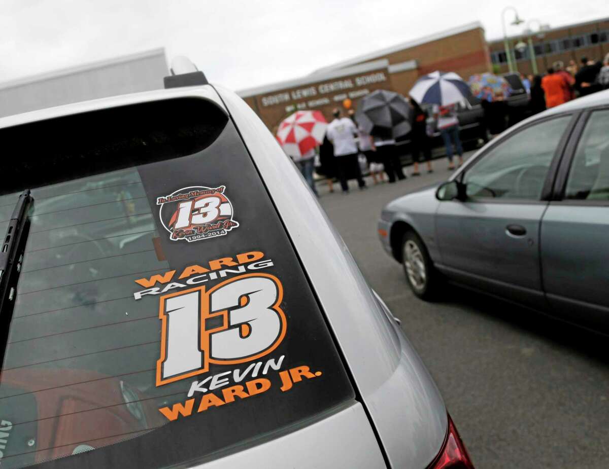 A Kevin Ward Jr. racing sticker is displayed on a vehicle outside South Lewis Central School after Ward’s funeral on Thursday in Turin, N.Y.