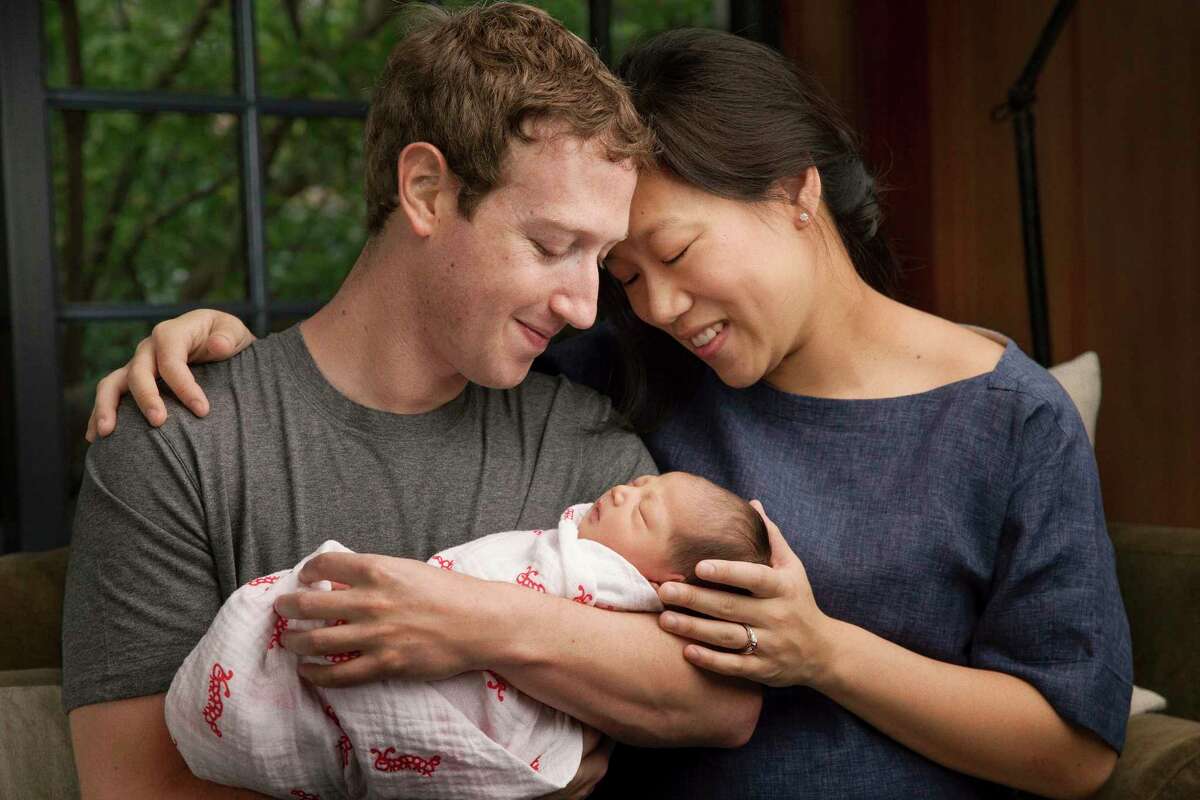 In this undated photo provided by Mark Zuckerberg, Max Chan Zuckerberg is held by her parents, Mark Zuckerberg and Priscilla Chan Zuckerberg. Facebook CEO Mark Zuckerberg and his wife announced the birth of their daughter, Max, as well as plans to donate most of their wealth to a new organization that will tackle a broad range of the world’s ills.