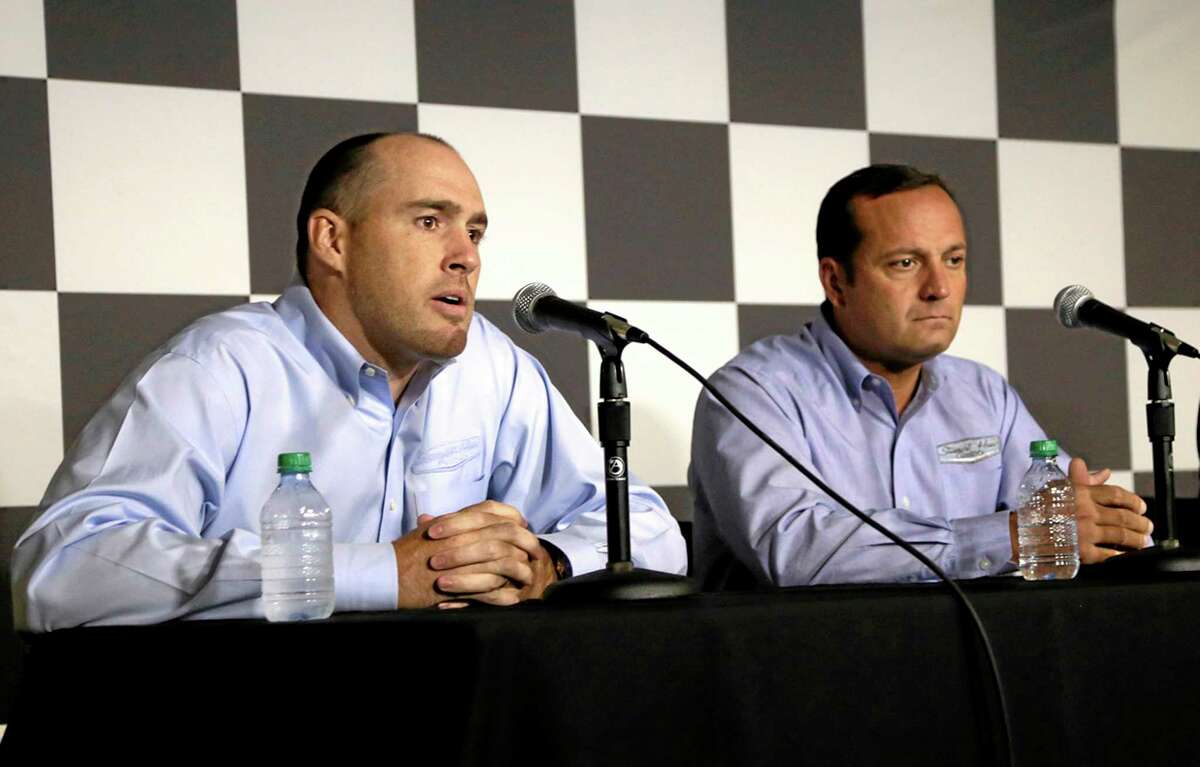 Stewart-Haas Racing executive vice president Brett Frood, left, speaks during a news conference as crew chief Greg Zipadelli looks on Friday at Michigan International Speedway in Brooklyn, Mich.
