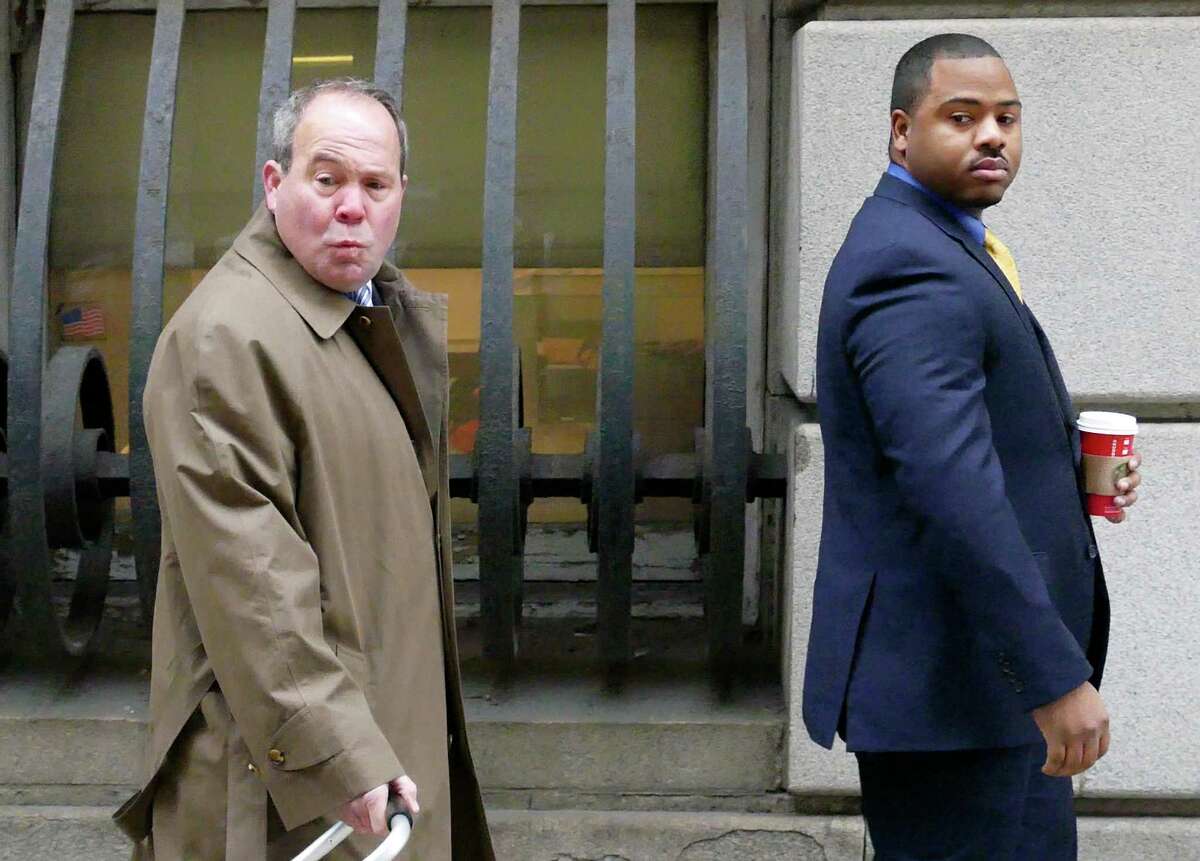 William Porter, right, one of six Baltimore city police officers charged in connection to the death of Freddie Gray, walks into a courthouse for jury selection in his trial, Monday, Nov. 30, 2015, in Baltimore. Porter faces charges of manslaughter, assault, reckless endangerment and misconduct in office.