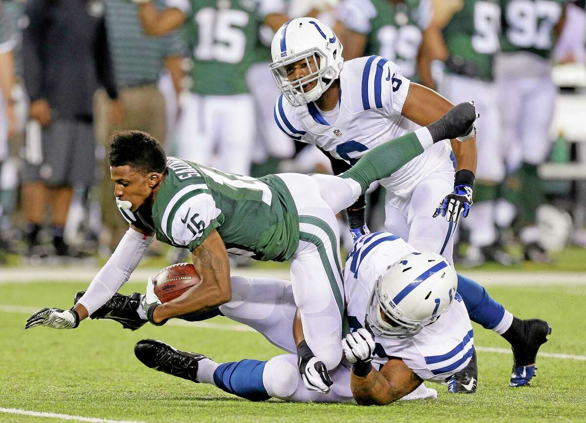 New York Jets wide receiver Jalen Saunders (16) is tackled by the Indianapolis Colts’ Cameron White (43) and cornerback Loucheiz Purifoy (6) after losing his helmet on a kickoff return in the fourth quarter of a preseason game Aug. 7 in East Rutherford, N.J.