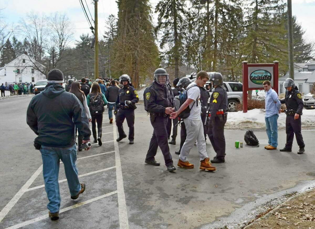 Police detain participants in the pre-St. Patrick's Day "Blarney Blowout" near the University of Massachusetts in Amherst, Mass. on Saturday, March 8, 2014. Amherst police said early Sunday that 73 people had been arrested after authorities spent most of the day Saturday attempting to disperse several large gathering around the UMass campus for the party traditionally held the Saturday before spring break. The partying carried through Saturday evening into early Sunday, and Amherst Police Capt. Jennifer Gundersen said in a statement that police were busy with numerous reports of fights, noise and highly intoxicated individuals.(AP Photo/The Republican, Robert Rizzuto) MANDATORY CREDIT