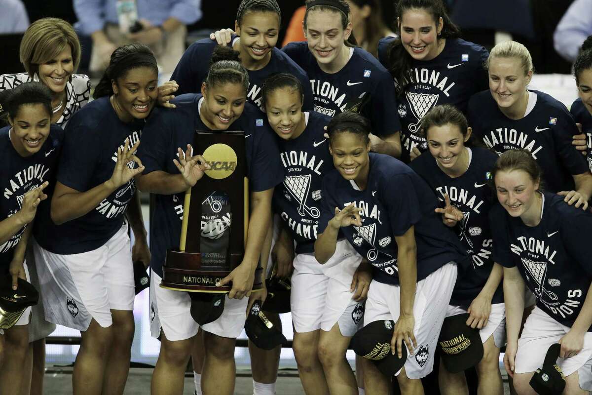 Connecticut players pose with the national championship trophy after the NCAA women’s Final Four tournament college basketball championship game against Notre Dame, Tuesday, April 7, 2015, in Tampa, Fla. Connecticut won 63-53. (AP Photo/Chris O’Meara)