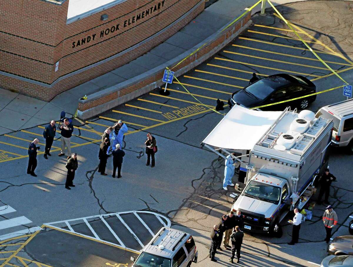 Officials on the scene outside of Sandy Hook Elementary School in Newtown, Conn., on Friday, Dec. 14, 2012.