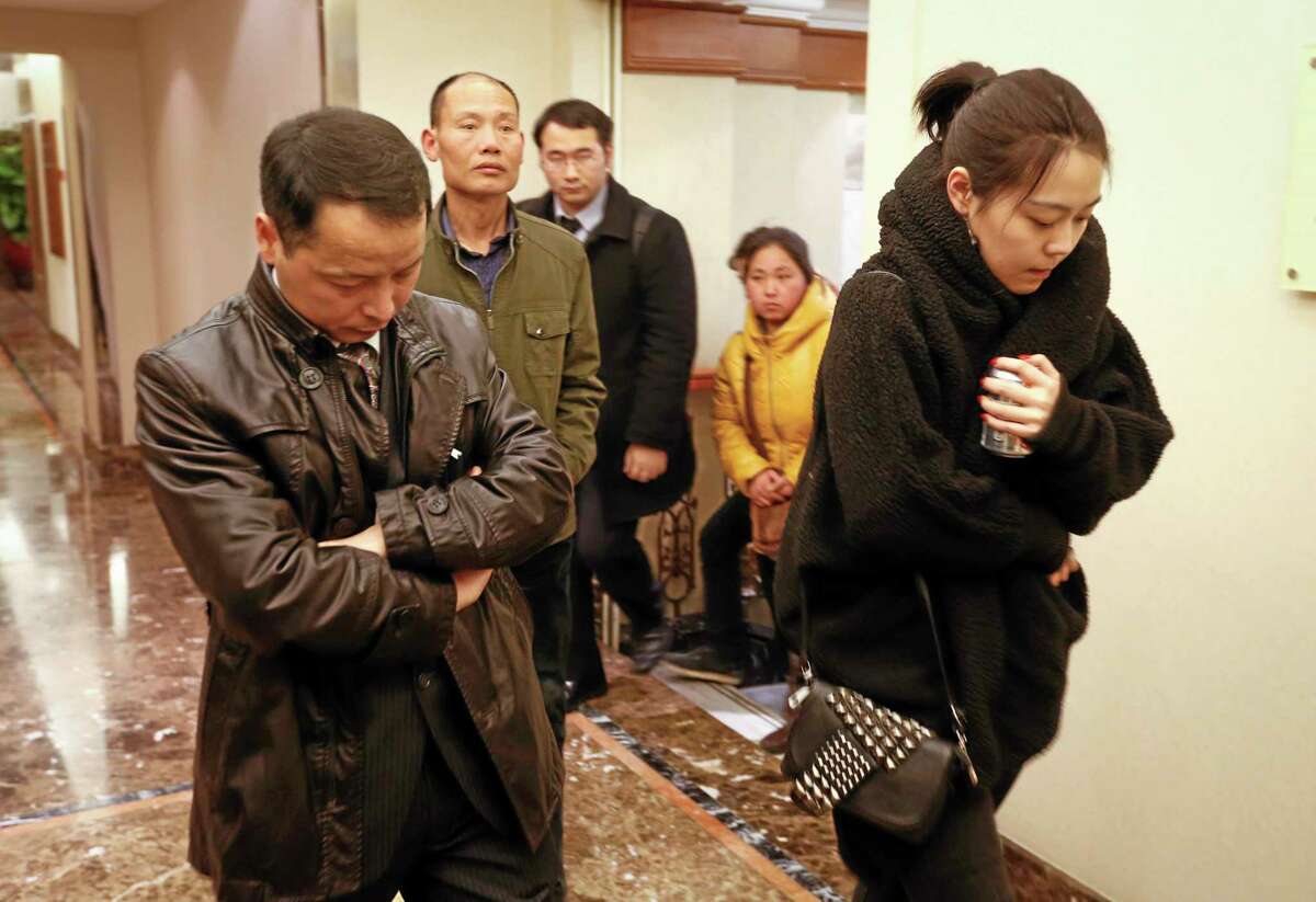 Family members arrive at a hotel which is prepared for relatives or friends of passengers aboard a missing airplane, in Beijing, China, Sunday, March 9, 2014. Search teams across Southeast Asia scrambled on Saturday to find a Malaysia Airlines Boeing 777 with 239 people on board that disappeared from air traffic control screens over waters between Malaysia and Vietnam early that morning. (AP Photo/Vincent Thian)