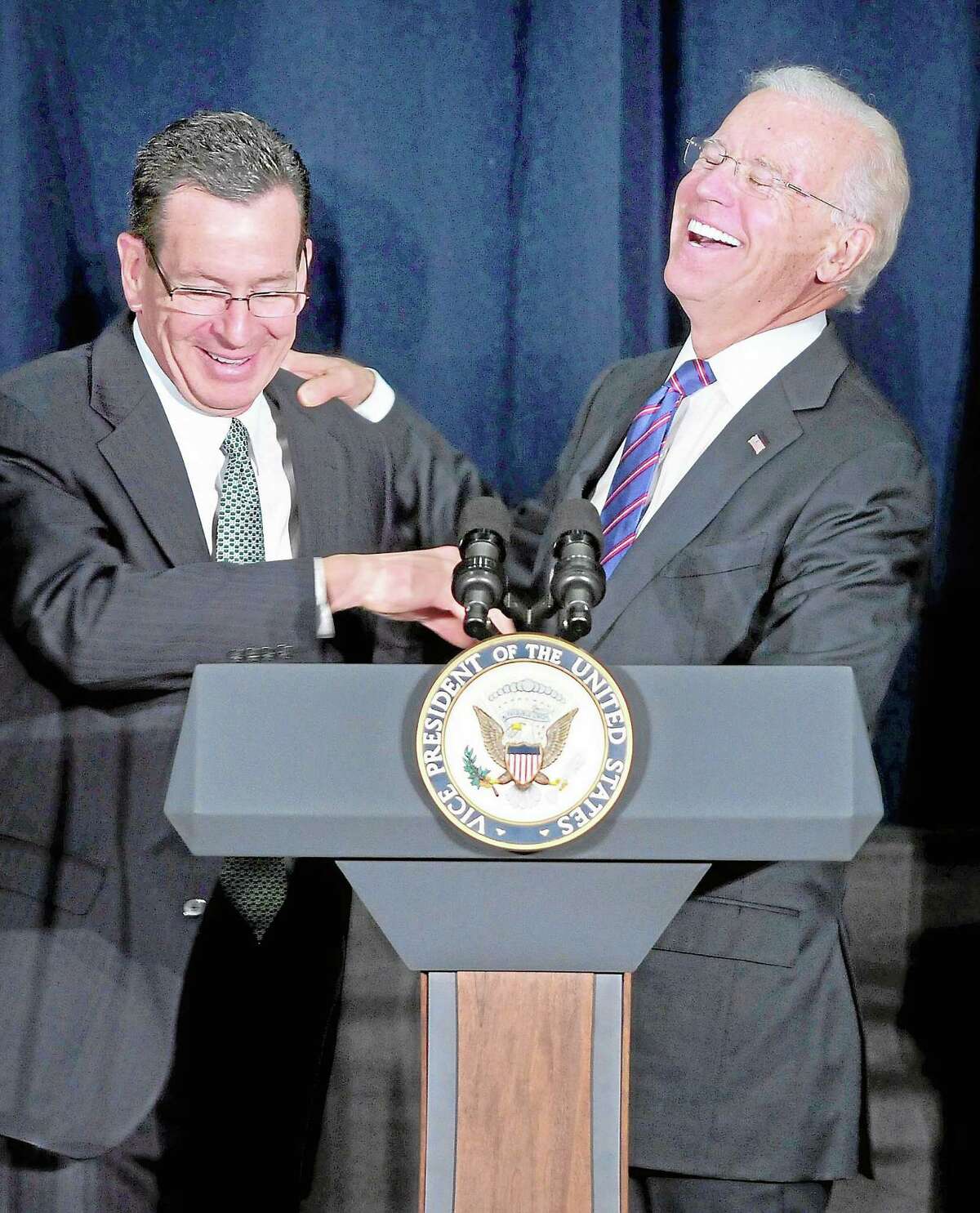 Gov. Dannel Malloy (left) jokes with Vice President Joe Biden (right) as he begins to speak at a Conference on Gun Violence at the Campus Center Ballroom at Western Connecticut State University in Danbury on 2/21/2013. Malloy told the audience that Biden would mention his grandfather during his speech and when he did the audience laughed at the prediction coming true. ¬ Photo by Arnold Gold/New Haven Register