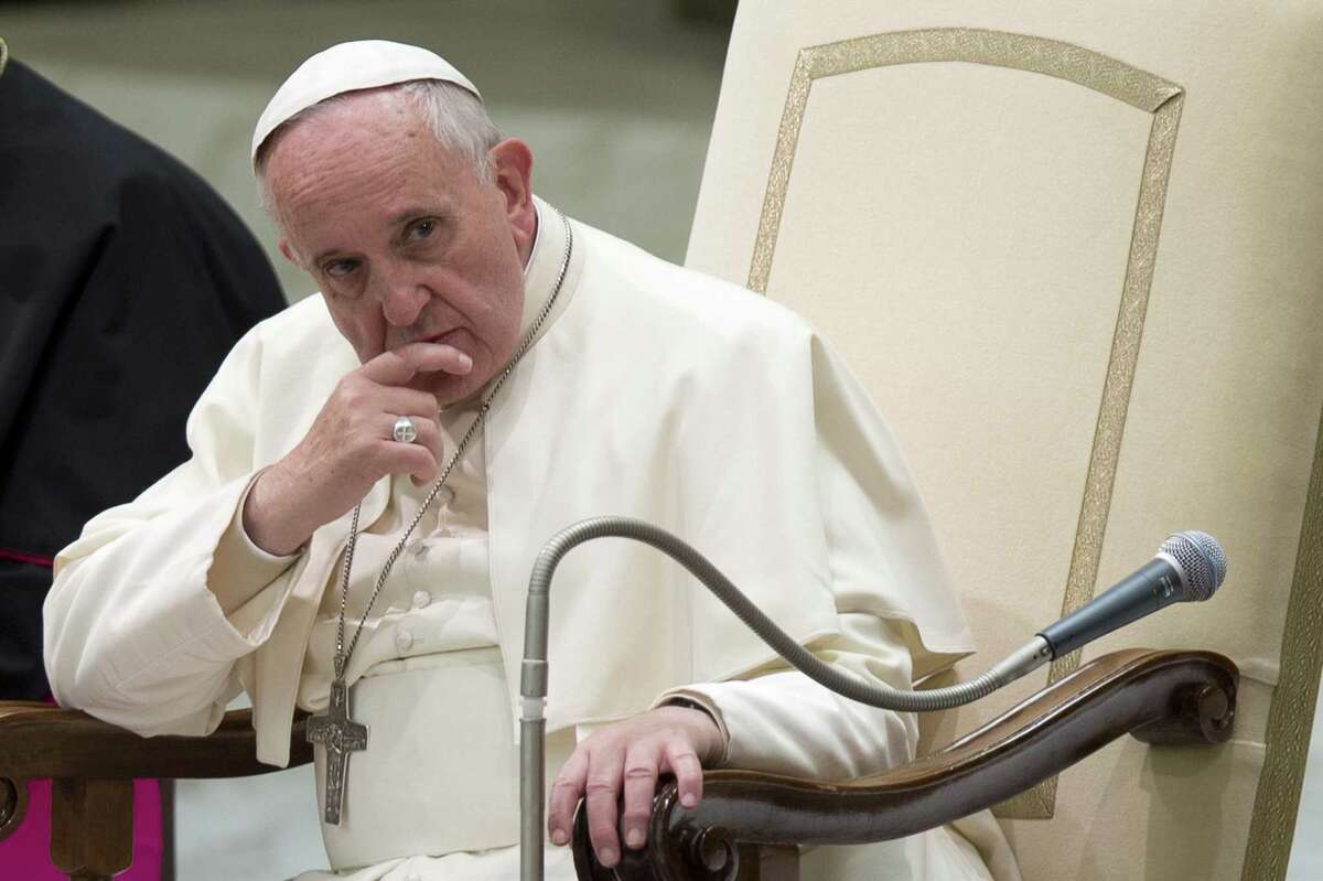 Pope Francis listens to a speech during a special audience he held for members of the FOCSIV Italian Catholic volunteers, at the Vatican, Thursday, Dec. 4, 2014. (AP Photo/Andrew Medichini)