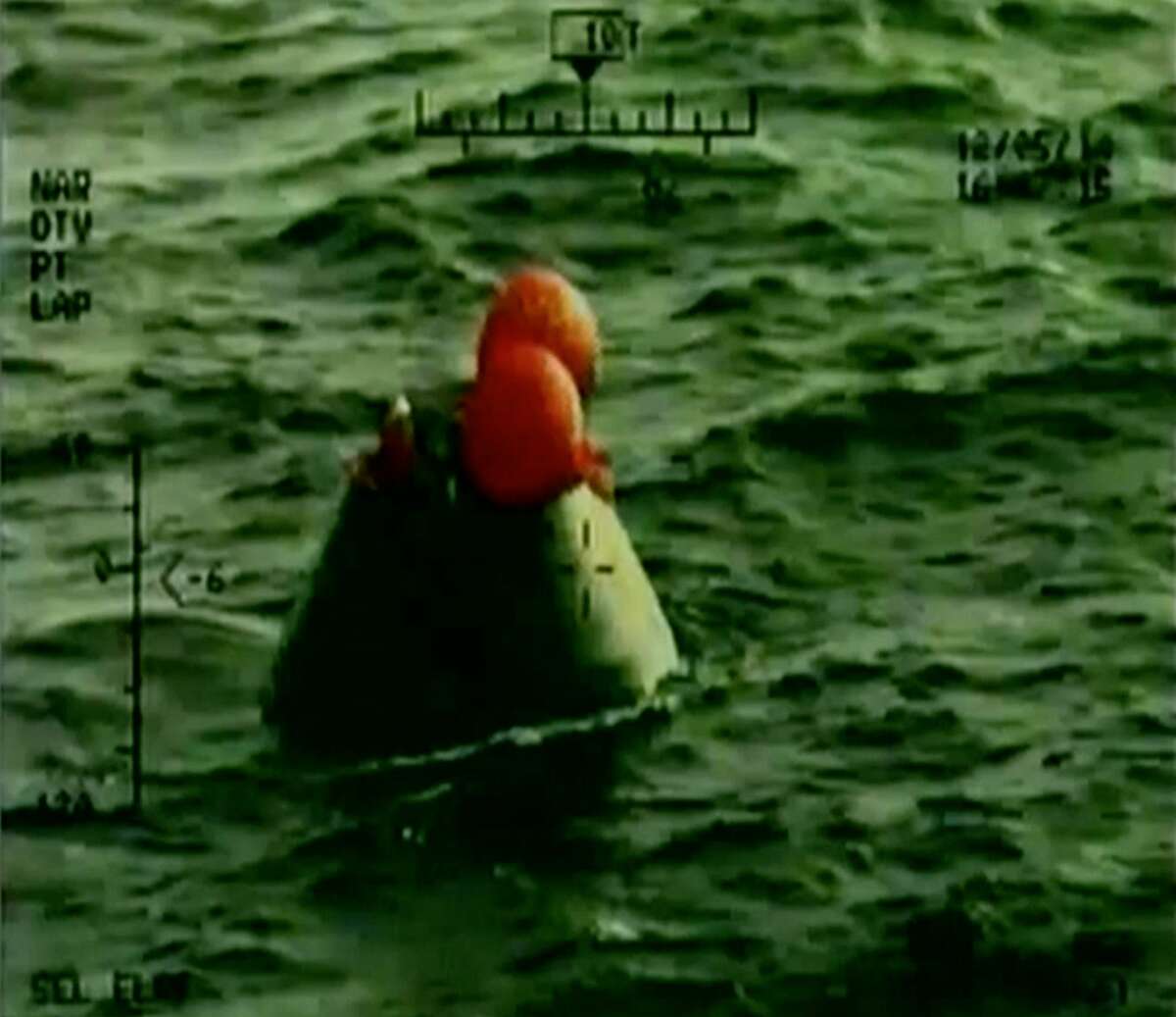 In this frame grab from NASA-TV, the Orion capsule floats after splashing down in the Pacific Ocean, Friday, Dec. 5, 2014, following a dramatic test flight that took it to a zenith height of 3,600 miles and ushered in a new era of human exploration aiming for Mars. (AP Photo/NASA)