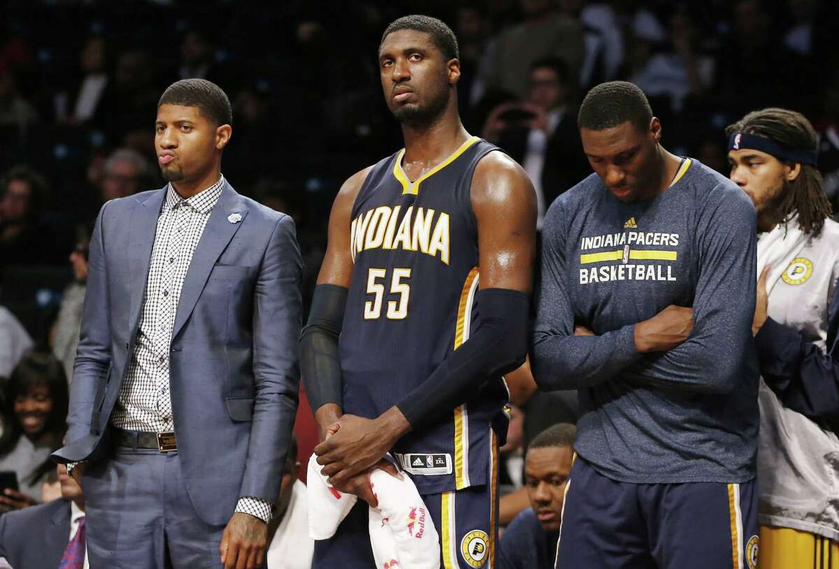 Indiana Pacers Paul George, left, Roy Hibbert (55) and teammates react in the waning seconds of a game against the Nets on Tuesday in Brooklyn.