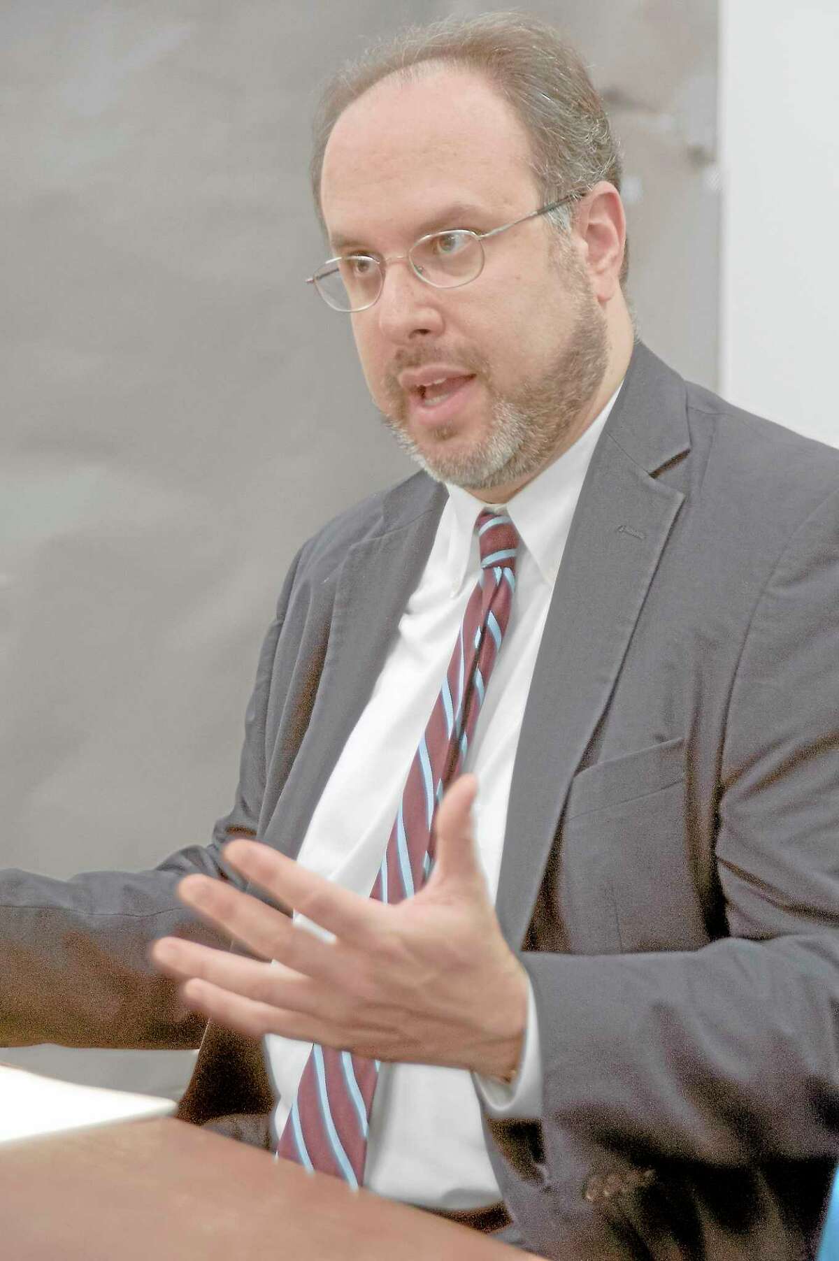 State Education Commissioner Stefan Pryor talks at an editorial bord meeting at the New Haven Register in 2013.