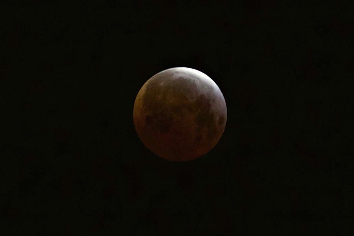 A lunar eclipse is observed as seen from Echo Park district of Los Angeles on Saturday, April 4, 2015. Early risers in the western U.S. and Canada were treated to the spectacle before dawn Saturday. The moment when the moon was completely obscured by Earth’s shadow lasted several minutes, making it the shortest lunar eclipse of the century.
