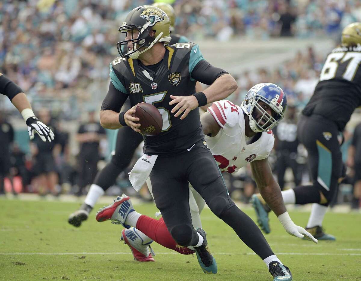 Jaguars quarterback Blake Bortles scrambles away from New York Giants defensive end Robert Ayers during Sunday’s game in Jacksonville, Fla.