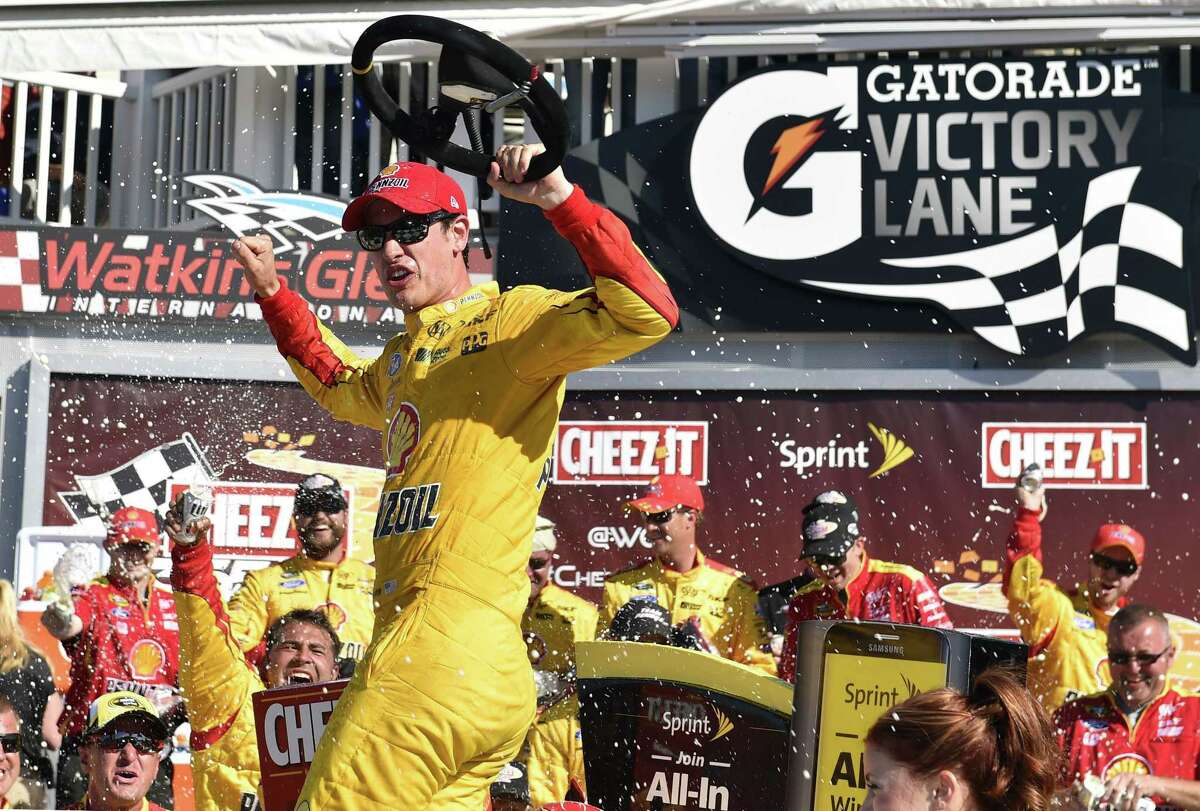 Joey Logano celebrates in Victory Lane after winning the NASCAR Sprint Cup race on Sunday at Watkins Glen International in Watkins Glen. N.Y.