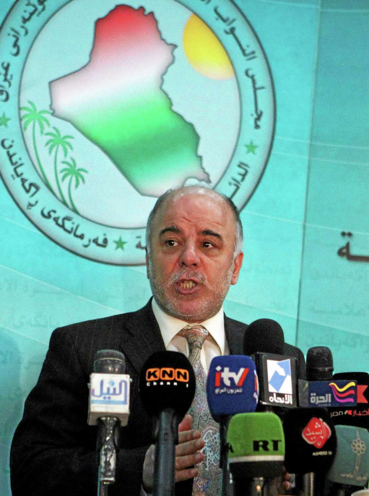 FILE - In this Saturday, Dec. 5, 2009 file photo, Shiite lawmaker Haider al-Ibadi speaks to the press after an Iraqi Parliament session about the election law in Baghdad, Iraq. On Monday, Aug. 11, 2014, Iraq's largest coalition of Shiite political parties chose the Deputy Parliament Speaker Haider al-Ibadi to be its candidate to lead the government in a major defeat for incumbent Prime Minister Nouri al-Maliki just hours after he declared himself the rightful candidate and put troops on the street. Critics say the Shiite al-Maliki contributed to the crisis by monopolizing power and pursuing a sectarian agenda that alienated the country's Sunni and Kurdish minorities. (AP Photo/Karim Kadim, File)