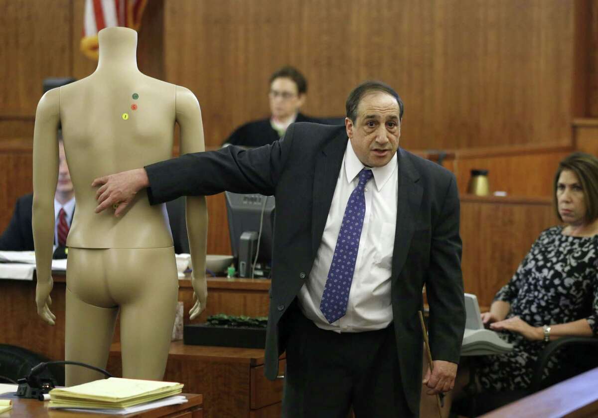 William Zane, of the Massachusetts state medical examiner’s office, points to a mannequin while testifying about the location of bullet wounds in the body of Odin Lloyd during the murder trial of Aaron Hernandez on Thursday in Fall River, Mass.