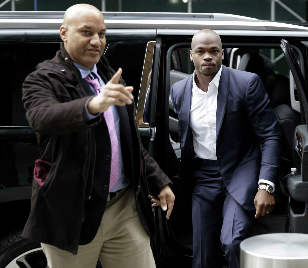 Adrian Peterson, right, arrives for a hearing for the appeal of his suspension in New York on Tuesday.