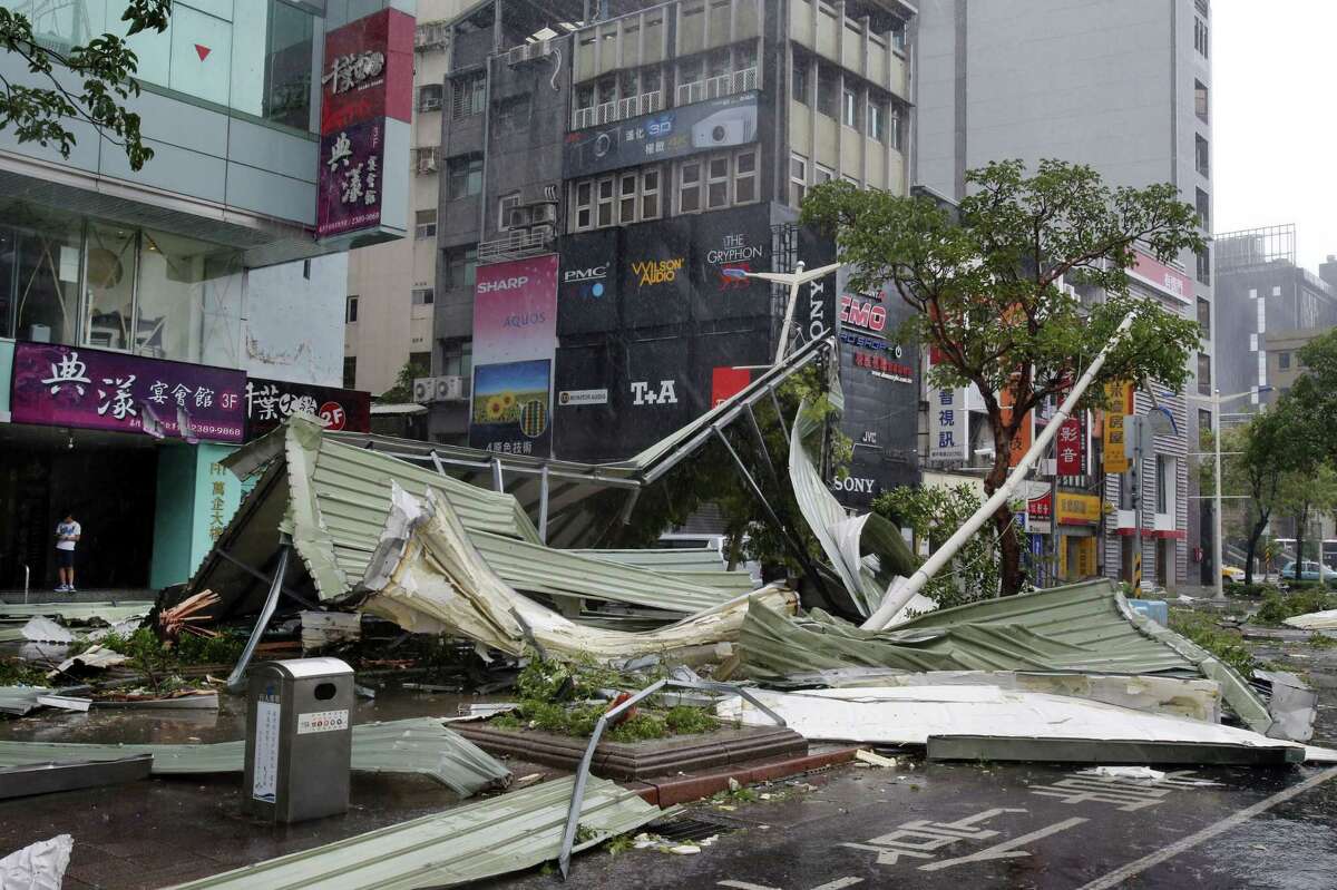 A street corner is filled with a mangled rooftop brought down by strong winds from Typhoon Soudelor in Taipei, Taiwan, Saturday, Aug. 8, 2015. Soudelor brought heavy rains and strong winds to the island Saturday with winds speeds over 170 km per hour (100 mph) and gusts over 200 km per hour (120 mph) according to Taiwan’s Central Weather Bureau.