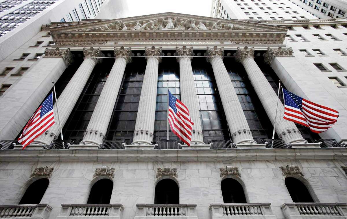 In this Feb. 10, 2011, photo, American flags fly in front of the New York Stock Exchange.