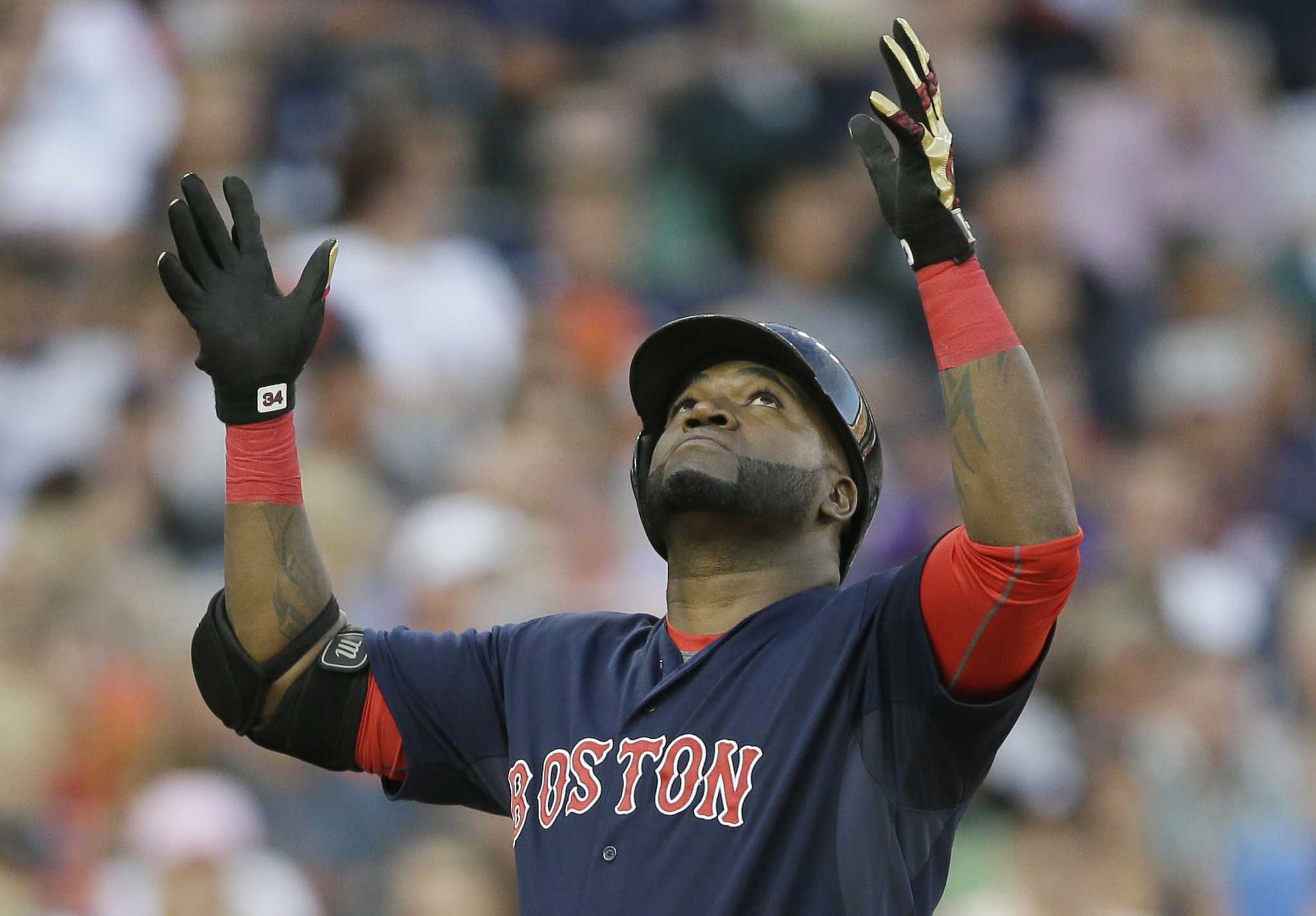 Boston Red Sox David Ortiz picks up reliever Koji Uehara after the last out  against the Detroit Tigers in game three of the American League  Championship Series at Comerica Park in Detroit