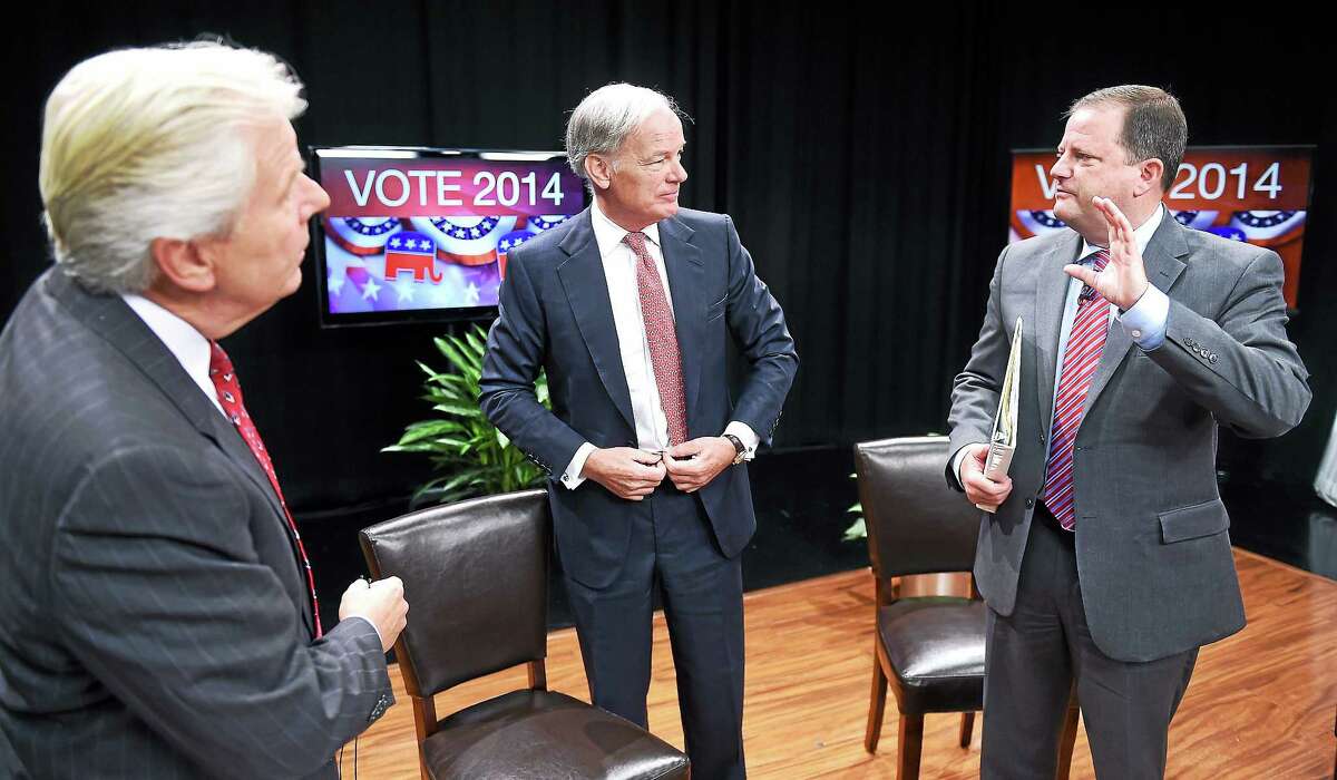 From left, Mark Davis of WTNH News 8, talks with Republican Gubernatorial candidates Tom Foley and John McKinney after the Connecticut Governor’s Race, Republican Primary Forum at WTNH in New Haven Sunday.