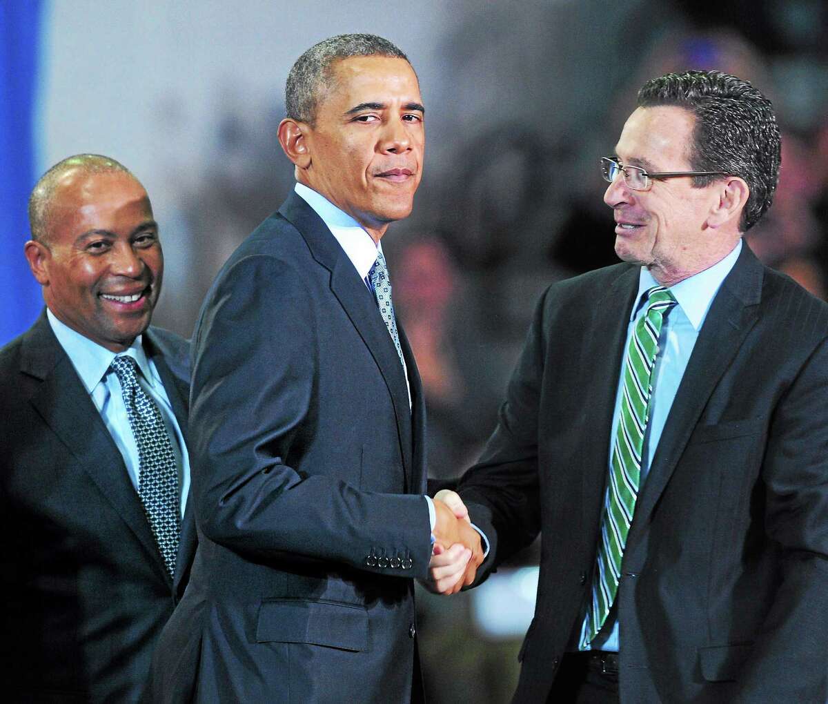 President Barack Obama shakes hands with Gov. Dannel P. Malloy after delivering a speech about raising the minimum wage at Central Connecticut State University in New Britain Wednesday. At left is Massachusetts Gov. Deval Patrick.
