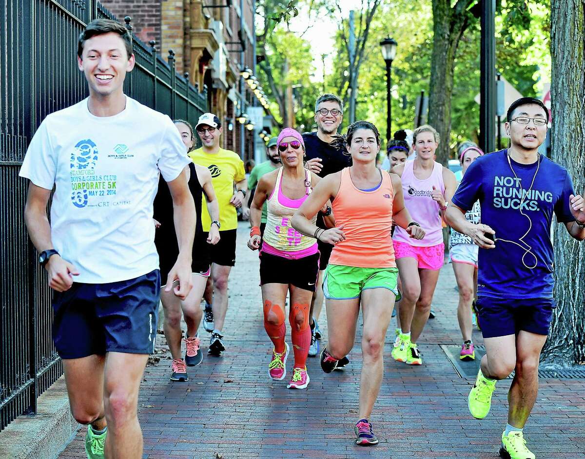 Area runners run on Elm Street Tuesday during the New Haven Road Race 20K training series in preparation for the annual Labor Day event.