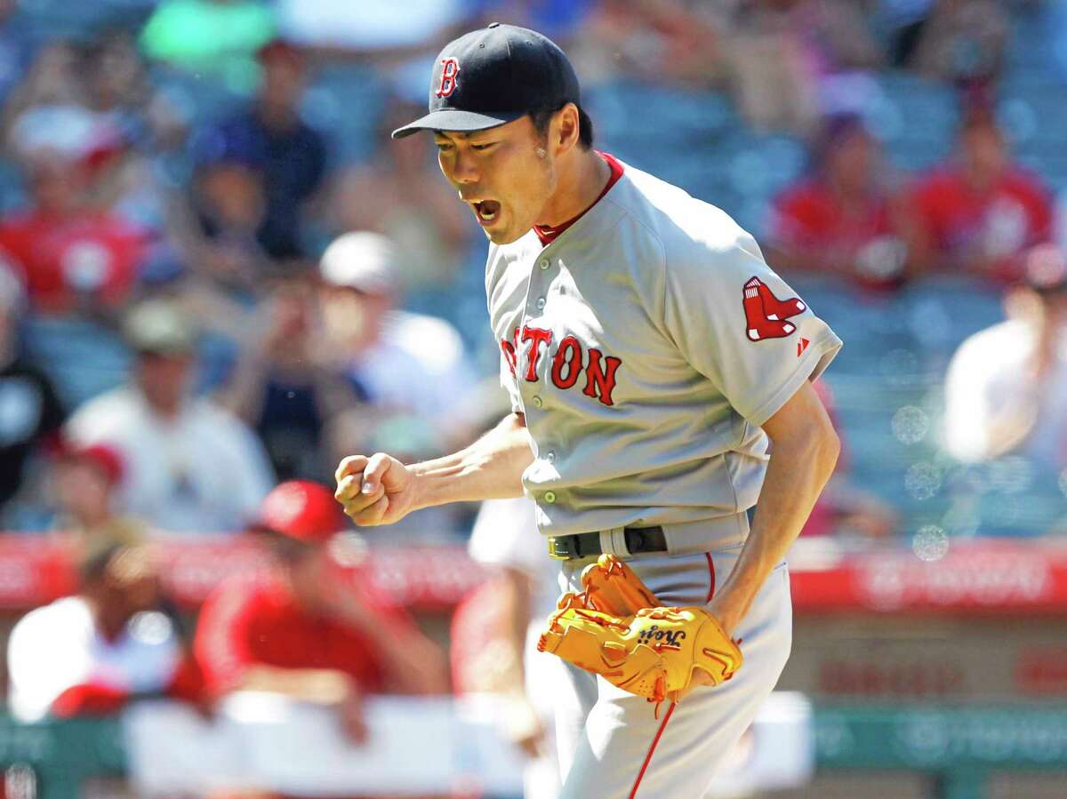 Red Sox closer Koji Uehara reacts after striking out Josh Hamilton to end Sunday’s game.