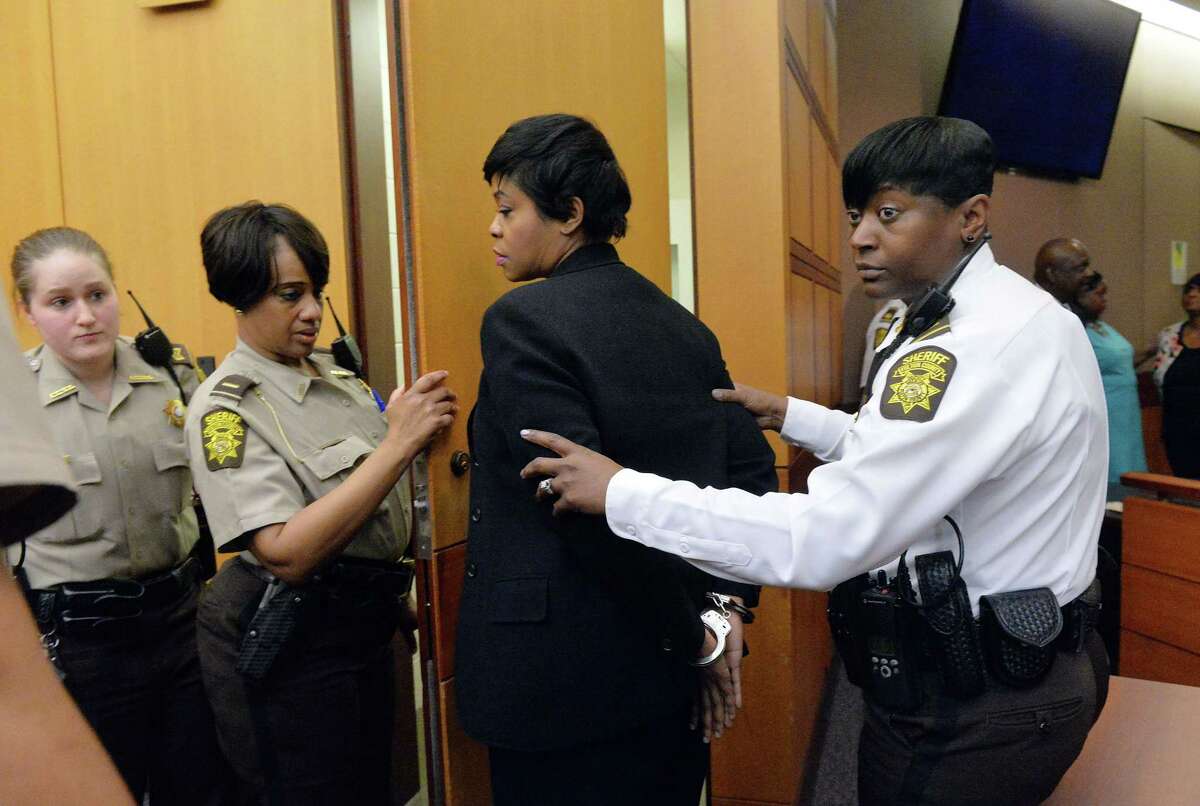 Former Deerwood Academy assistant principal Tabeeka Jordan, center, is led to a holding cell after a jury found her guilty in the Atlanta Public Schools test-cheating trial, Wednesday, April 1, 2015, in Atlanta. Jordan and 10 other former Atlanta Public Schools educators accused of participating in a test cheating conspiracy that drew nationwide attention were convicted Wednesday of racketeering charges.