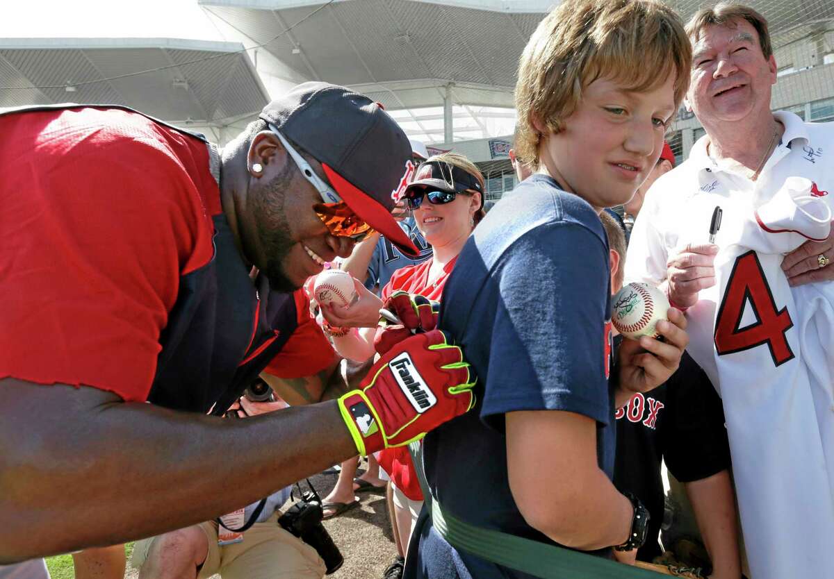 Red Sox designated hitter David Ortiz signs an autograph on a shirt for a fan before Boston’s spring training game against the Tampa Bay Rays on Tuesday in Fort Myers, Fla. The Rays won 8-0.